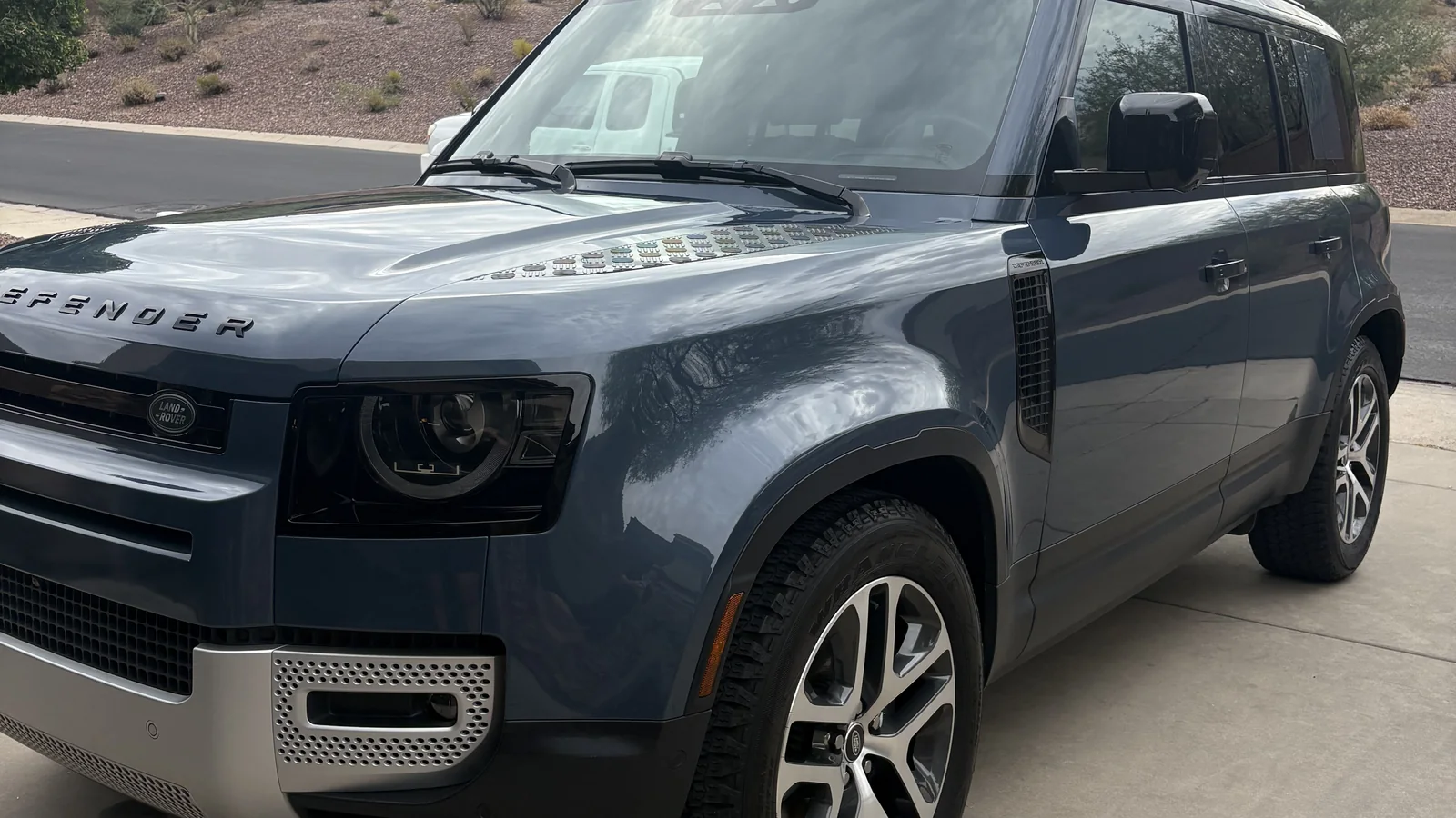 Blue Land Rover Defender with one stage polished and ceramic coated paint in a Phoenix driveway