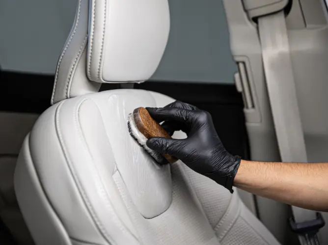 Leather care conditioner applied to tan leather car seat Phoenix AZ