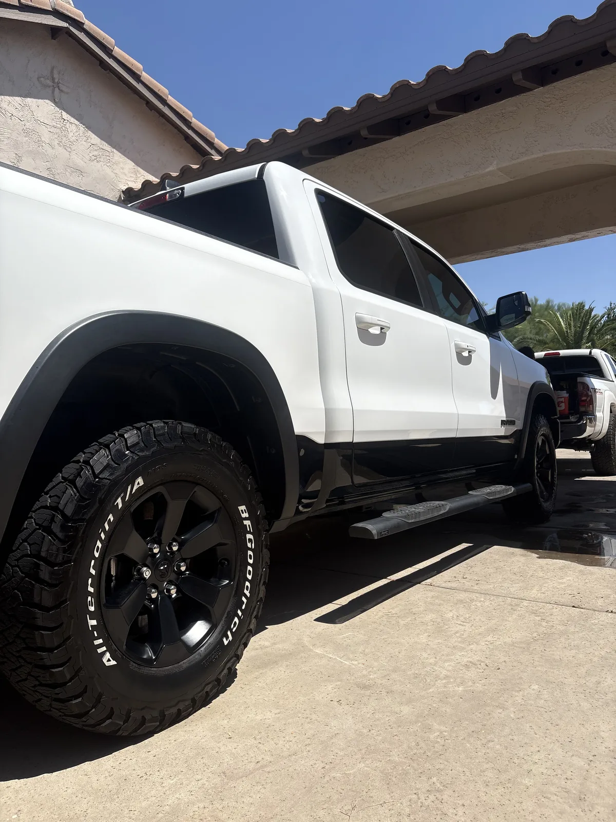 White RAM 1500 Rebel after a full detail in an Arizona driveway