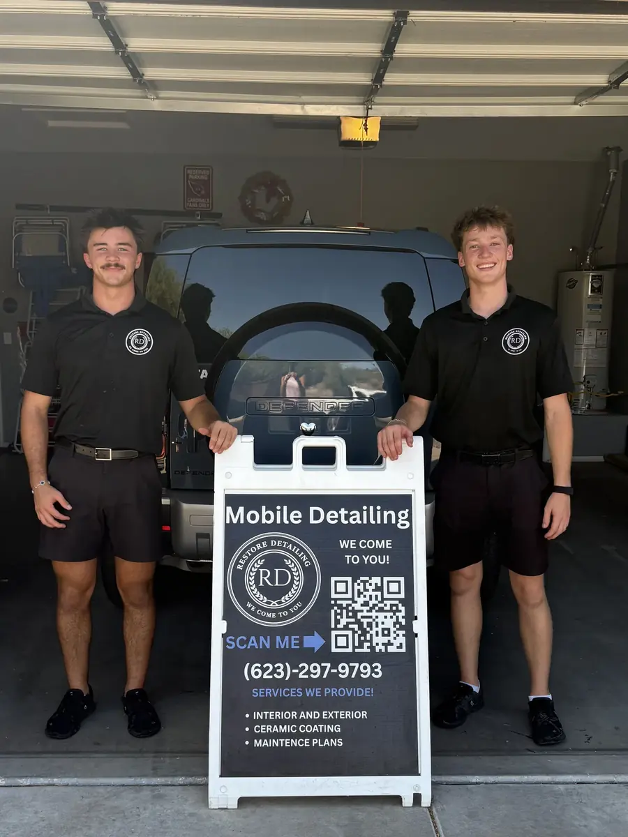 Cooper and Colin of Restore Detailing with the mobile detailing sign